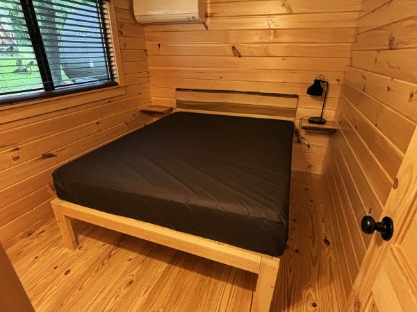 Queen bed in Master Bedroom in Bumblebee Cabin at Austin Lake Park in Toronto OH